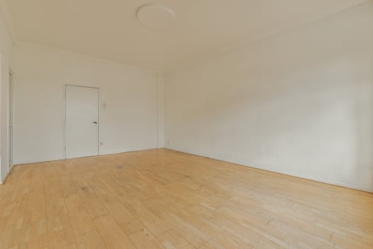 An empty room with hardwood floors and white walls photo