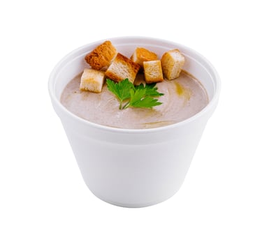 Mushroom cream soup with croutons in a white to-go cup photo