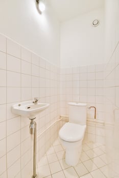 A white bathroom with a toilet and sink photo