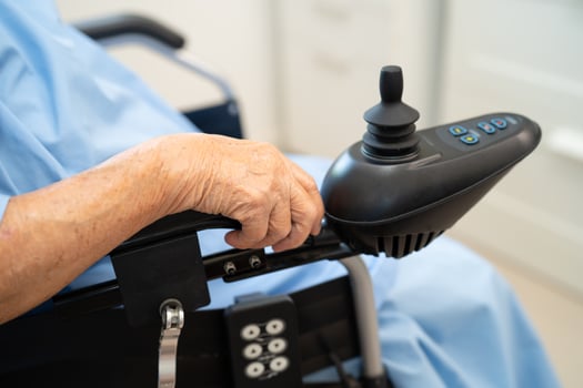 Asian senior woman patient on electric wheelchair with remote control at hospital, healthy strong medical. photo
