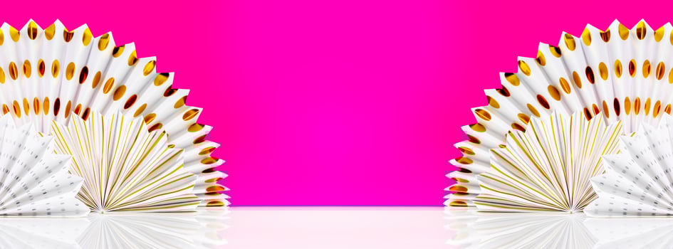 White table with decoration paper fans on magenta background photo