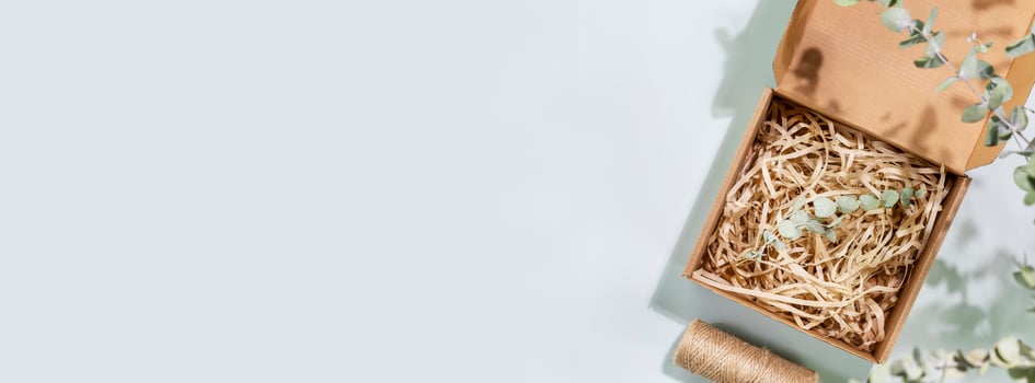 Eco friendly shopping banner with cardboard box with shredded paper photo
