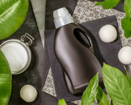 Bottle of washing gel for black clotheson black textile napkins photo