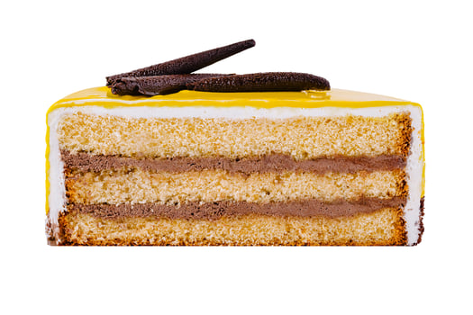Delicious piece of cake with yellow icing and chocolate decoration isolated on white background photo