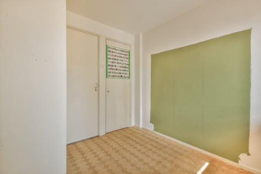 A room with a green wall and a door photo