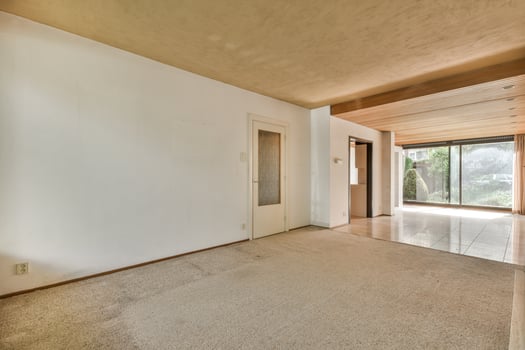 A room with a carpeted floor and a door photo
