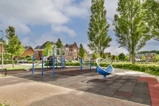 A playground with a swing set and a slide photo
