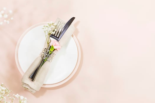 Spring holiday table settings on light pink background with spring white flowers photo