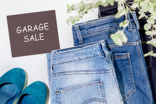Second hande clothes and chalkboard with inscription Garage Sale photo