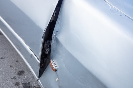 detail of a car door deformed by an impact photo