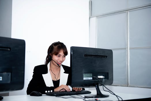 call center smiling business operator customer support team phone services agen working and talking with headset on desktop computer at call center photo