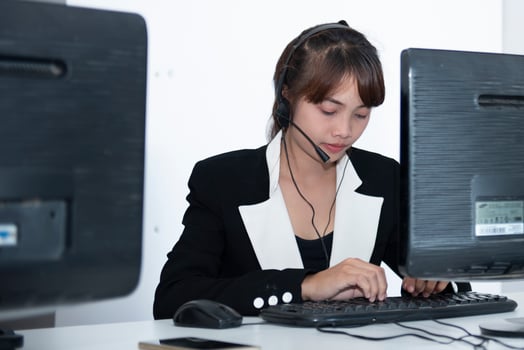 call center smiling business operator customer support team phone services agen working and talking with headset on desktop computer at call center photo