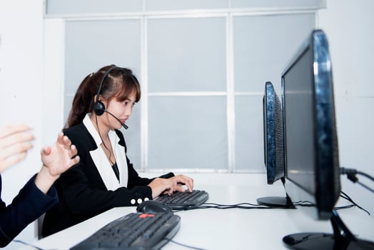 call center smiling business operator customer support team phone services agen working and talking with headset on desktop computer at call center photo