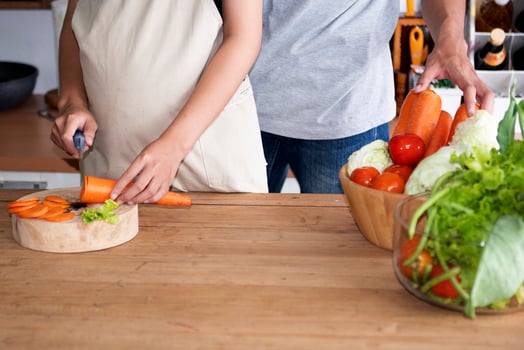 A family of pregnant women and couples are preparing a healthy meal with green vegetables at home. photo