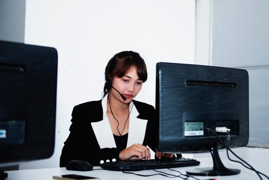 call center smiling business operator customer support team phone services agen working and talking with headset on desktop computer at call center photo