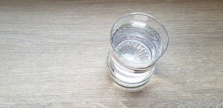 Top view of glass of water on brown wooden with copy space. Object, food and refreshment drinking on wood background concept. photo