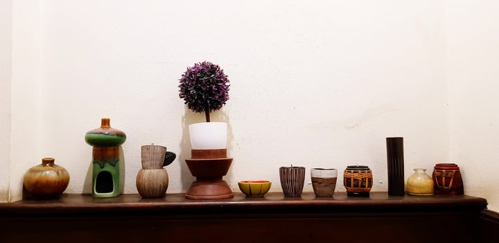 Many flower pot, earthenware or ceramic putting on wooden shelf or cabinet for decoration house with white wall background. Beautiful object for decorated house or room concept. photo