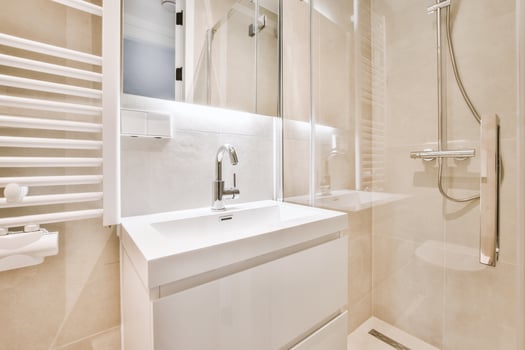 A bathroom with a white sink and a shower photo
