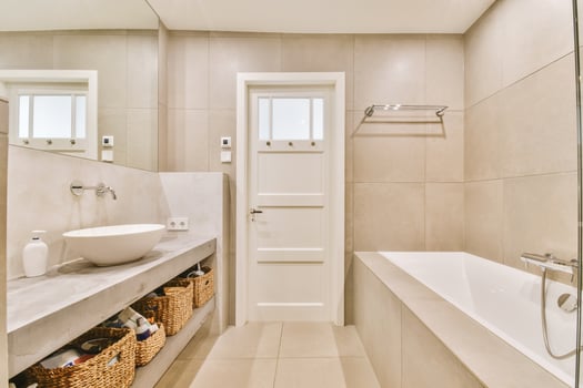 A bathroom with a sink, tub and mirror photo