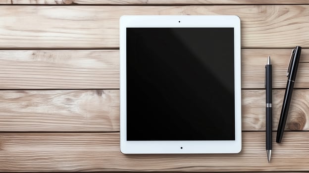 A sleek tablet rests on a wooden surface beside a stylish pen photo