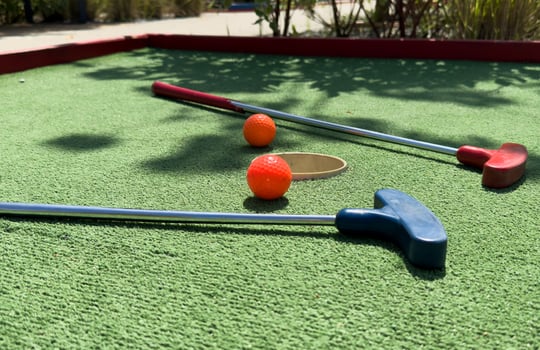 Closeup of player play mini golf with ball photo