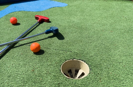 Closeup of player play mini golf with ball photo