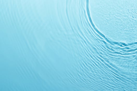 Blurred Blue Water Ripple with Bubbles and Sunlight Reflection - Calm and Clear Background photo