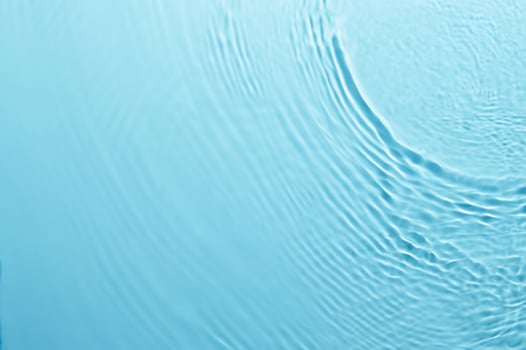 Blurred Blue Water Ripple with Bubbles and Sunlight Reflection - Calm and Clear Background photo