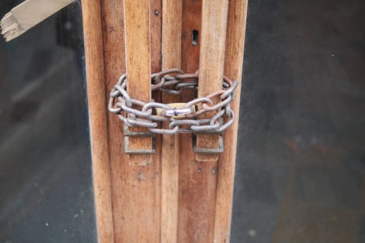 A set of locked wooden doors secured with a robust chain and a sturdy padlock for safety photo
