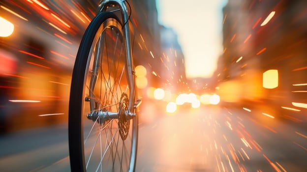 Closeup of a bicycle wheel spinning in motion, with reflections of the bustling cityscape in the handlebars. photo