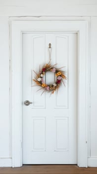 Dried Flower Wreath Hanging on White Door photo