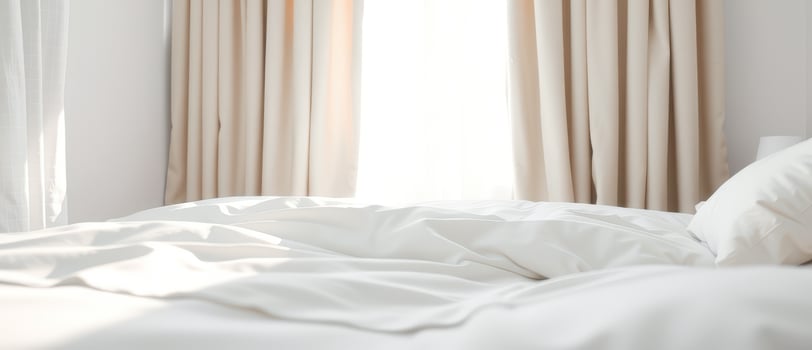 White Bedding and Curtains in a Bright Bedroom photo
