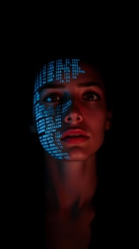 Woman with blue digital code projected on her face photo