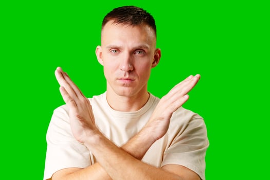 Man Gesturing No Signal Against Bright Green Background studio shot photo