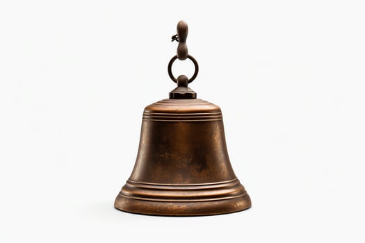 A closeup photograph of an old bronze bell with a smooth surface and a small loop at the top for hanging. photo