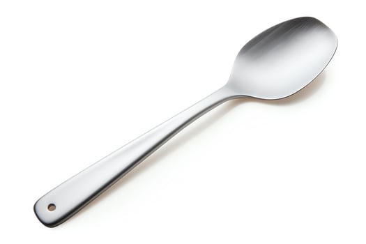 A stainless steel spoon with a round bowl and a long, thin handle. The spoon is isolated on a white background. photo