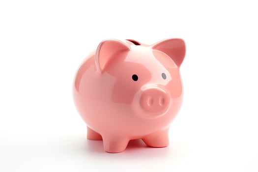 A pink piggy bank sits on a white background photo