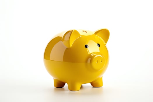 A yellow piggy bank sits on a white background photo