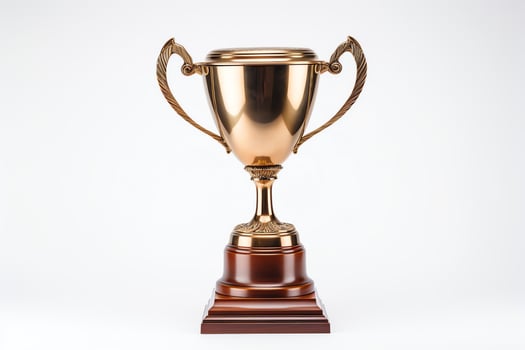 A gold trophy with a wooden base. photo