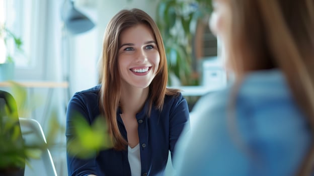 Young female entrepreneur smiles while meeting with a coworker in the office photo