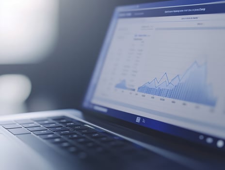 Open laptop on a desk displays a line chart showing positive growth, symbolizing progress and success in business with data for decision-making photo