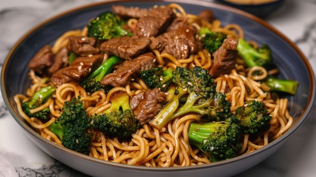 A Bowl of Savory Beef, Broccoli, and Noodles With Sesame Seeds photo