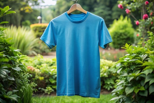 Blue t - shirt hanging on a clothes hanger in the garden photo