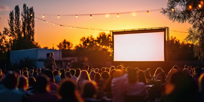 Outdoor cinema at sunset captivated audience enjoys film under twilight sky photo