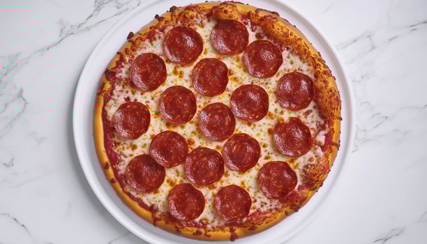 Pepperoni pizza with sausage slice, cheese and tomato, on white table photo