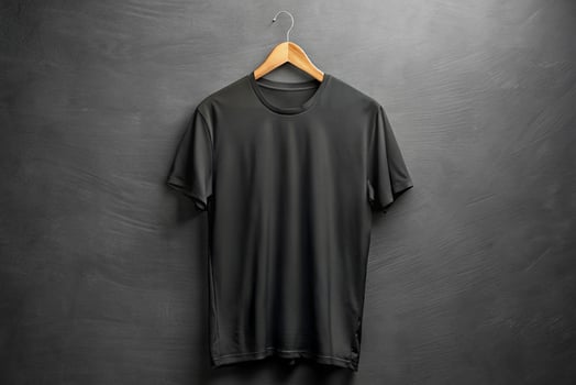 Black t - shirt hanging on a wooden hanger photo