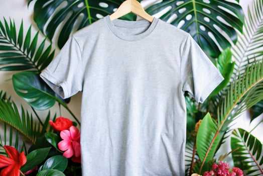 A gray t - shirt hanging on a wooden hanger photo