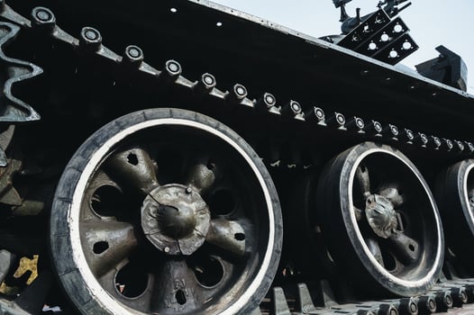 metal caterpillar track of old Soviet military tank in close-up photo