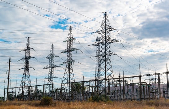 High-voltage lines on steel structures with wires against the background of the sky with clouds photo