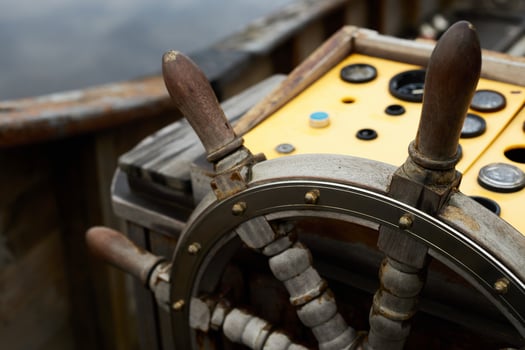 A close-up view of a wooden ship's wheel on a boat photo
